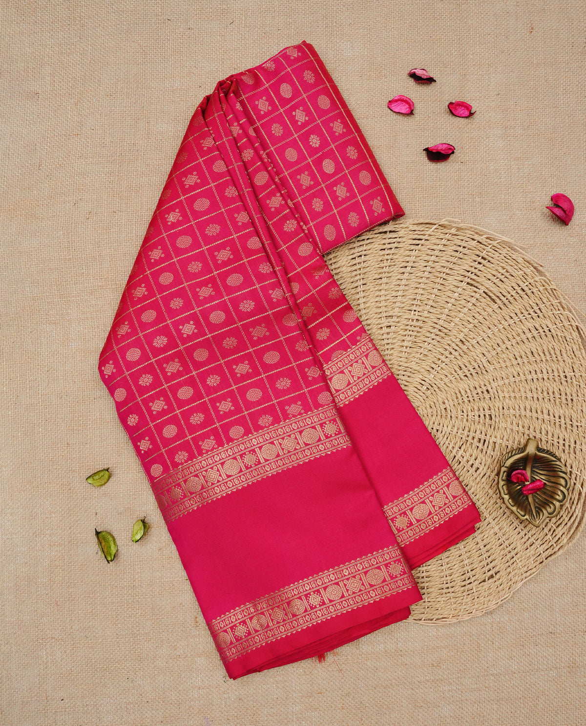 Magenta colour Traditional Kancheepuram silk saree featuring Gold zari Motifs on checks on body, complemented by self colour with traditional border, comes with matching blouse piece.