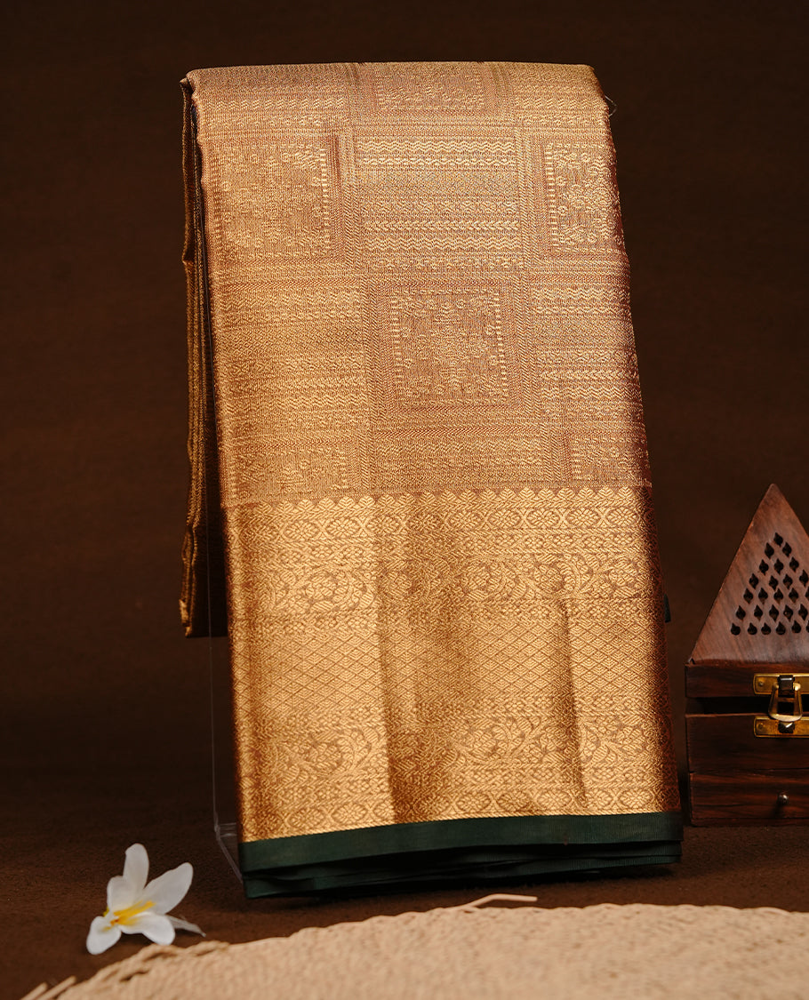 Gold colour semi tissue silk saree featuring gold zari pattern on body, contrast Green colour with gold zari traditional border, paired with matching blouse piece.