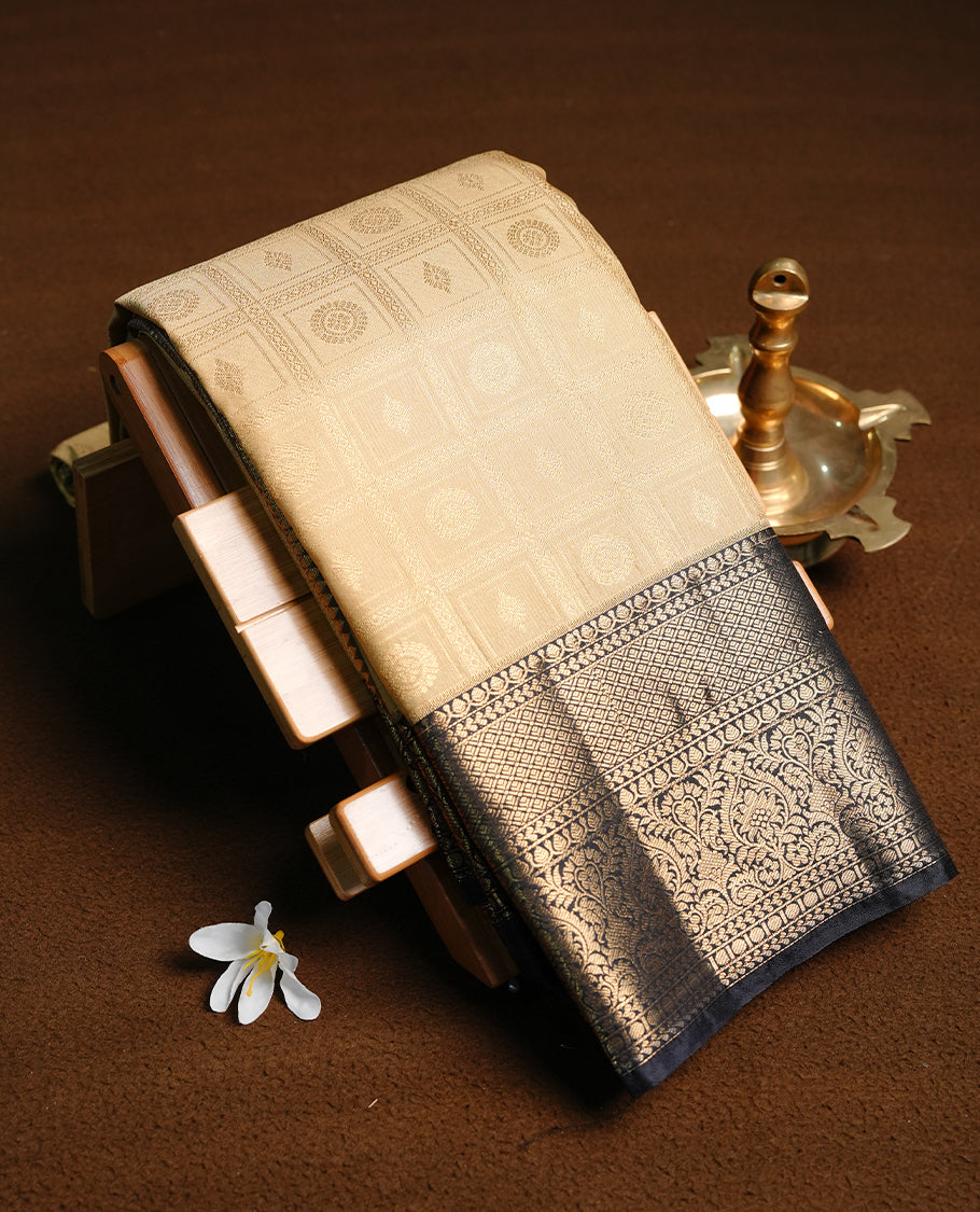 Gold colour semi wedding saree featuring gold zari check with motifs on body, contrast black colour with traditional border, paired with matching blouse piece.