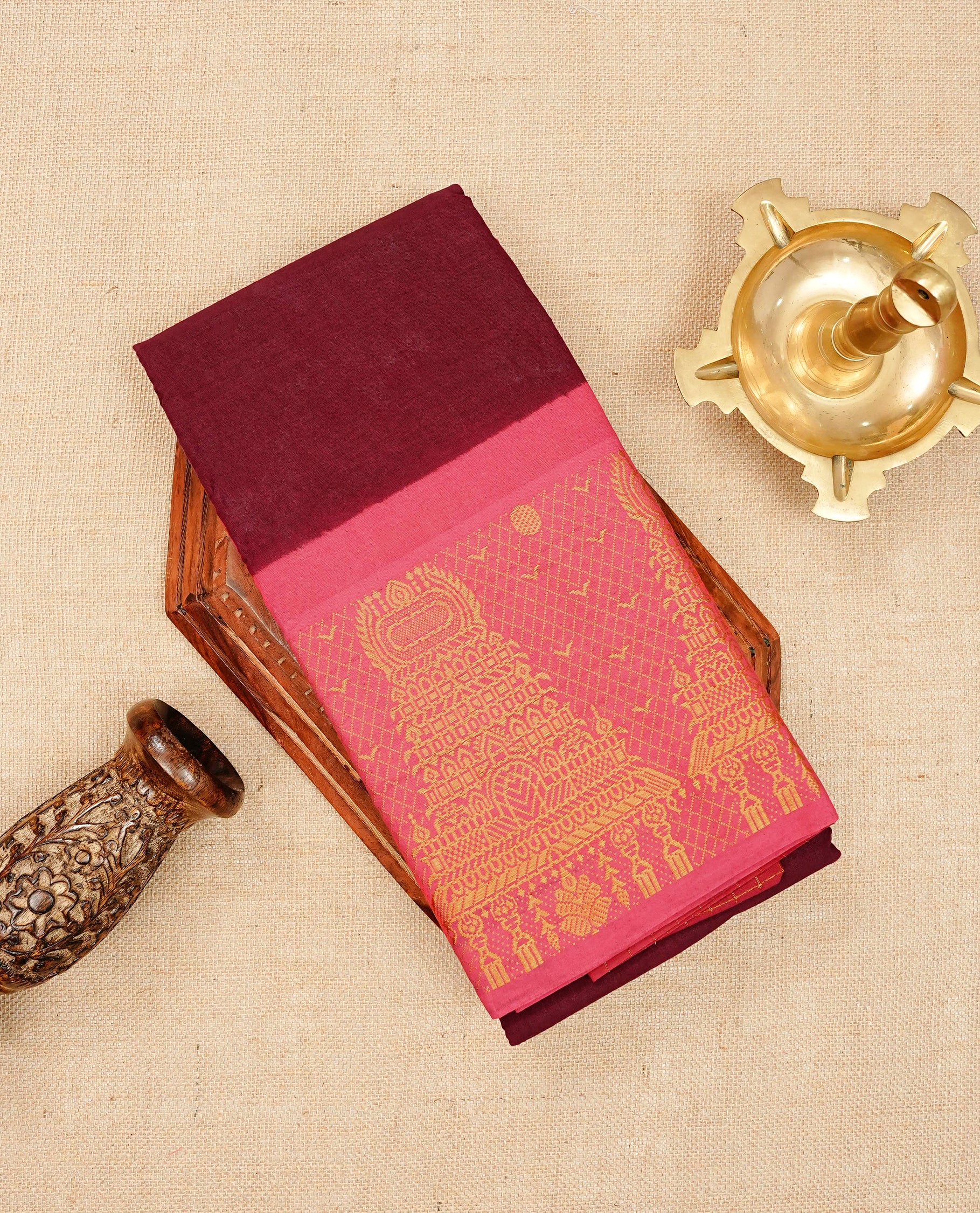 Maroon colour Sungudi cotton saree with a plain body, a contrast pink with temple zari border & pallu ,paired with a matching blouse piece.