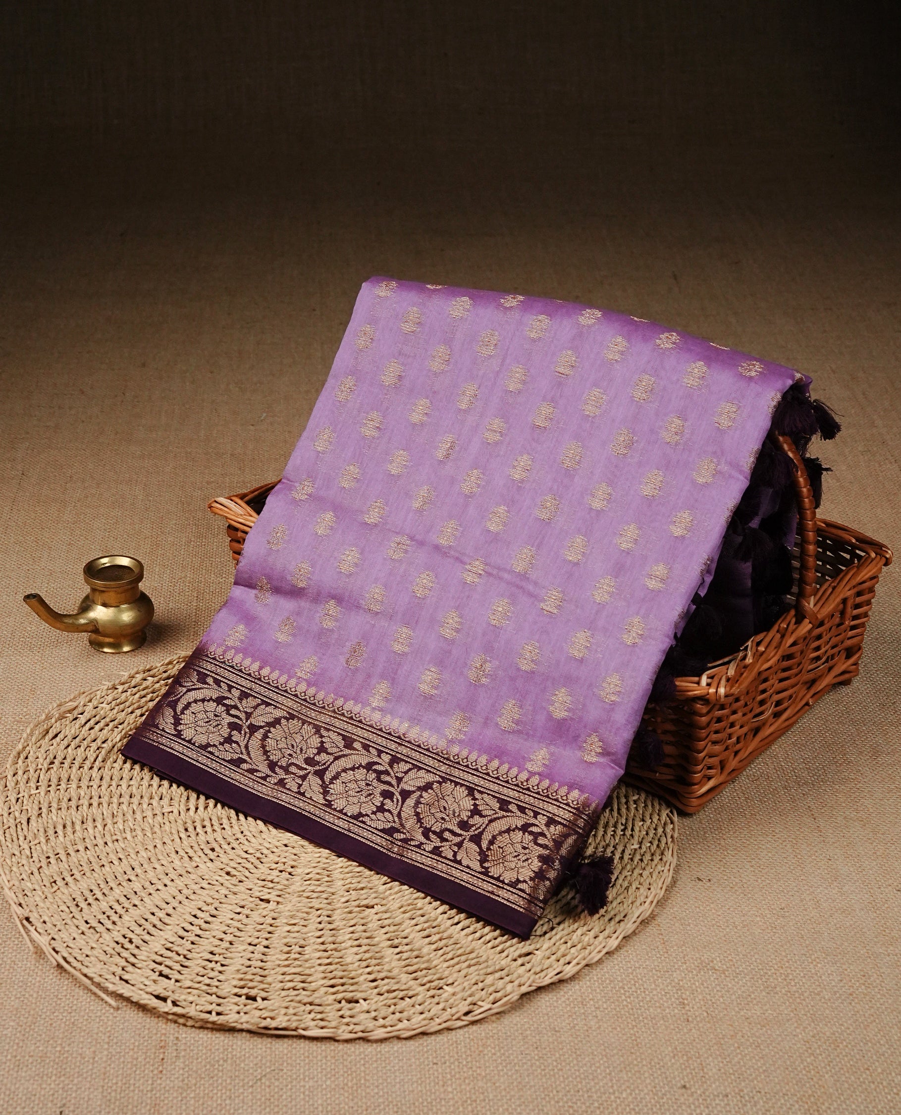 Lavender Colour Tussar Silk saree with antique zari butta motifs On body, a Maroon floral zari border, a rich zari pallu, and Paired With a matching blouse piece.