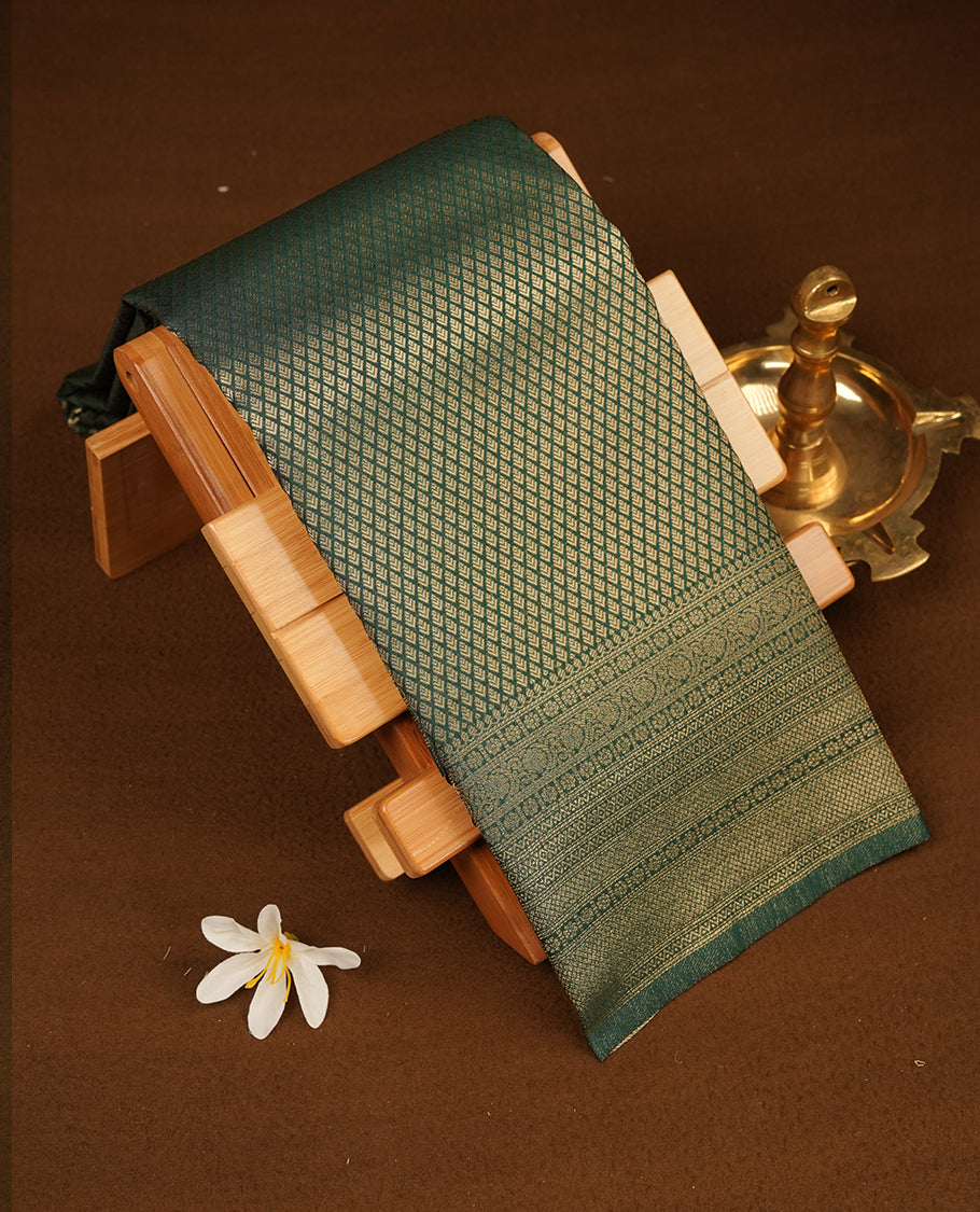 Dark green colour semi soft silk saree featuring gold zari motifs on across body, self colour border with traditional gold zari pattern, pallu and paired with matching blouse.