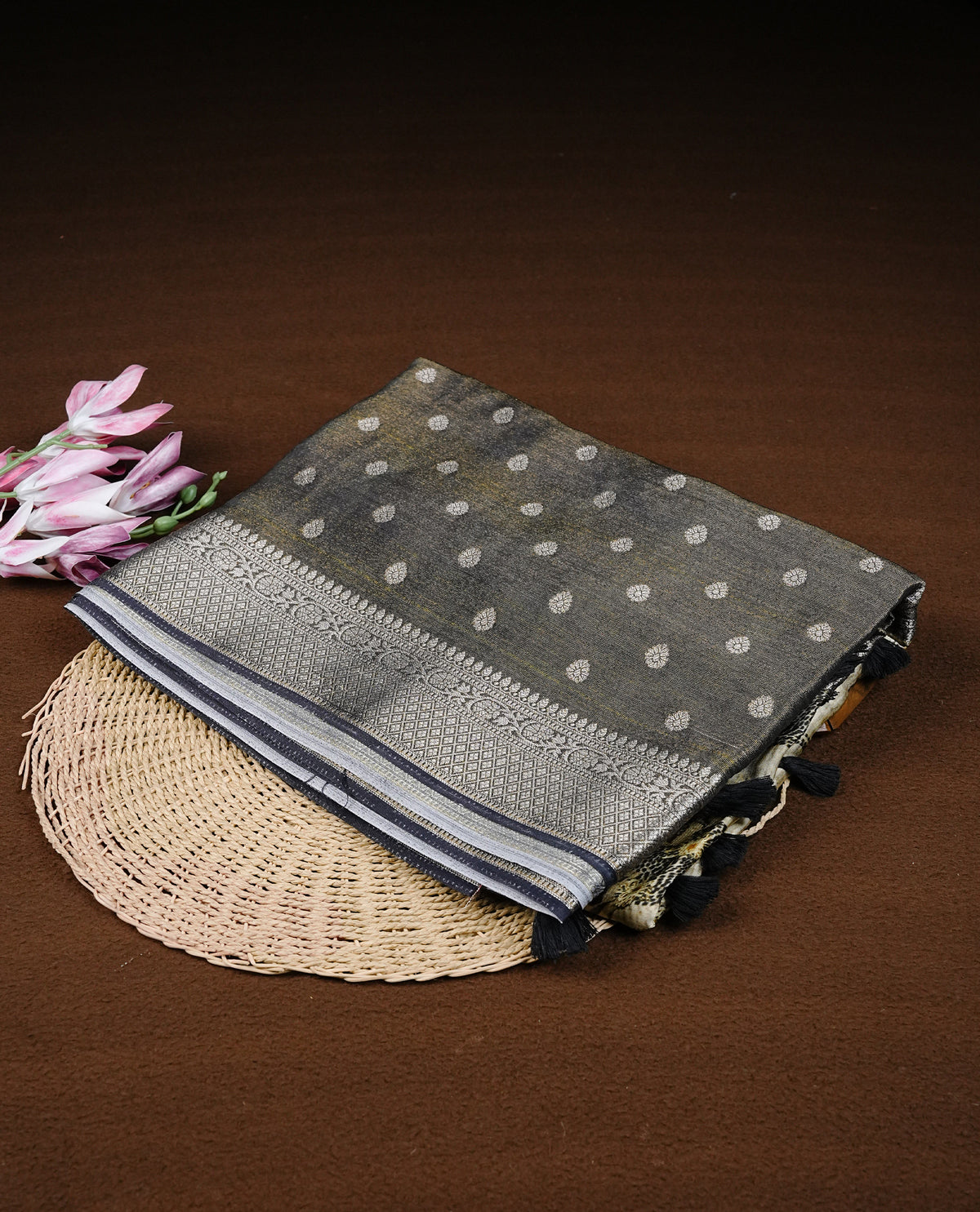 Black colour semi Banaras silk saree featuring with Digital printed body and traditional buttas on border, comes with matching blouse piece.
