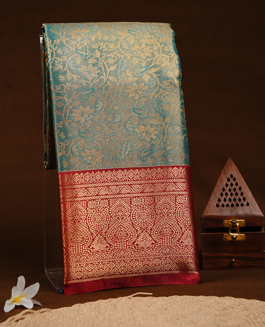 Green & gold double shade colour semi tissue silk saree featuring gold zari floral kodi pattern on body, contrast Maroon colour with gold zari traditional border, paired with matching blouse piece.