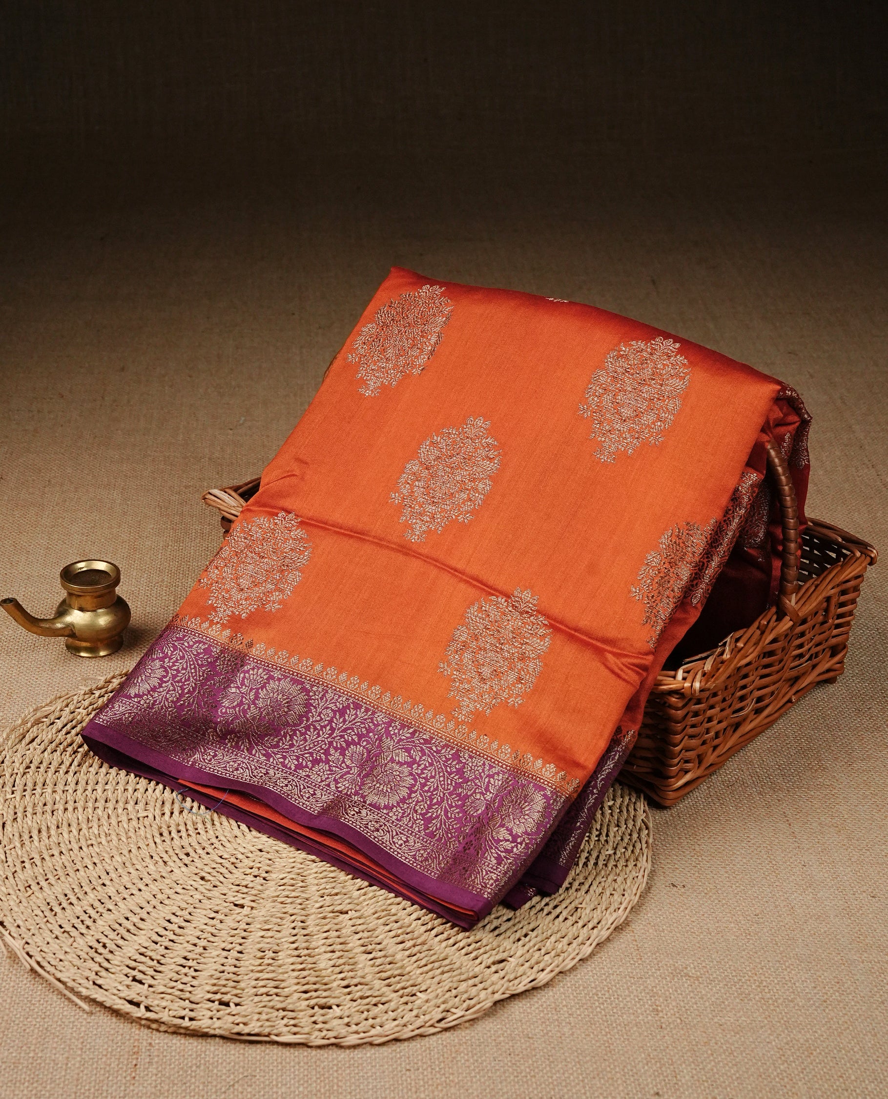 Orange Colour Tussar Silk saree with elegant antique zari floral motifs On Body, a contrasting Magenta zari border, a rich zari pallu, Paired With a matching blouse piece.