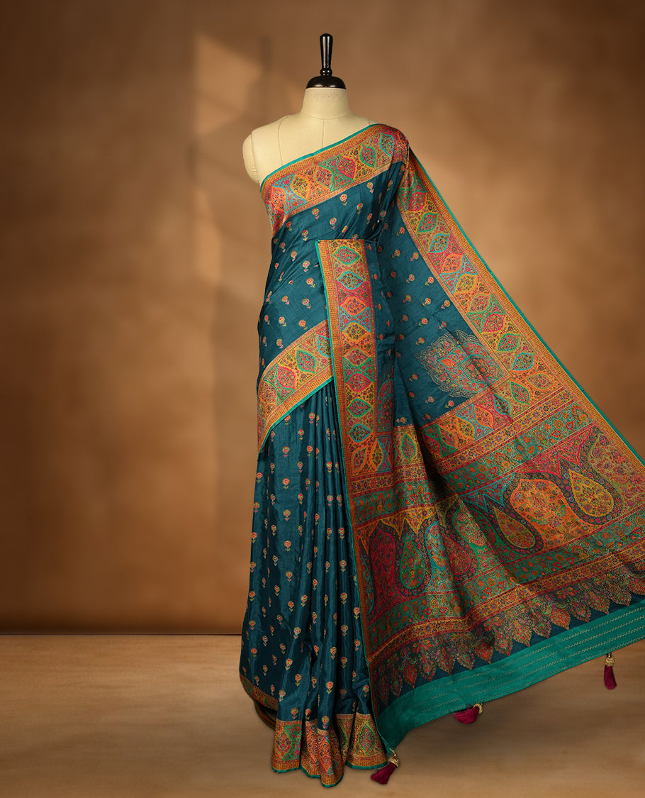 Dark teal blue colour Pashmina silk saree densely woven with intricate multicolour floral motifs across the body, framed by an opulent arabesque border and grand storytelling pallu, paired with a matching woven border blouse piece
