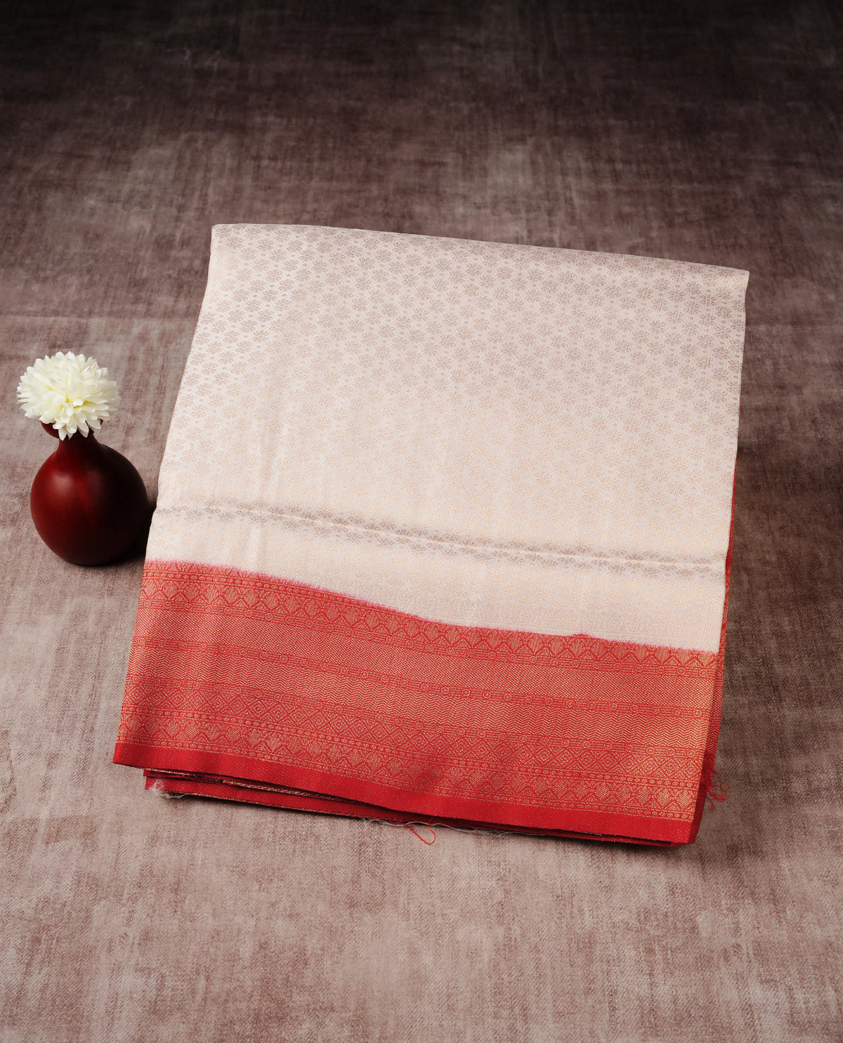 Cream colour softie silk saree featuring gold zari, rich pallu floral pattern brocade body, with contrasting red colour colour border.paired with matching blouse piece.