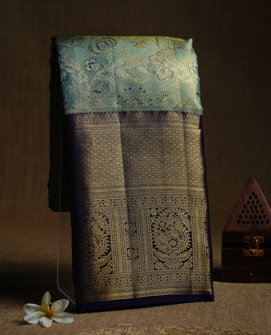 Gold & aqua double shade kancheepuram tissue silk saree featuring gold zari floral kodi pattern on body, complemented by contrast indigo colour with traditional border, paired with matching blouse piece.