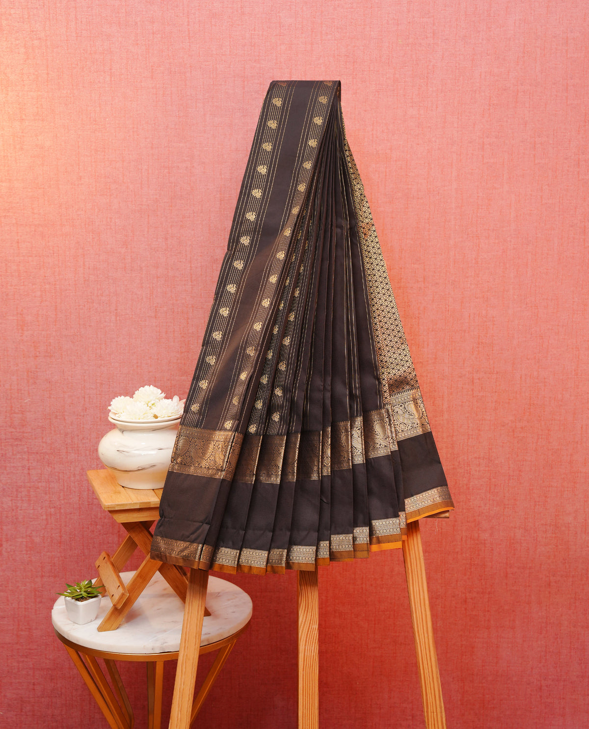 Coffee brown colour soft silk saree featuring gold zari tripes with peacock motifs on body, contrast self colour gold zari peacock & traditonal border, grand pallu comes with matching blouse piece.