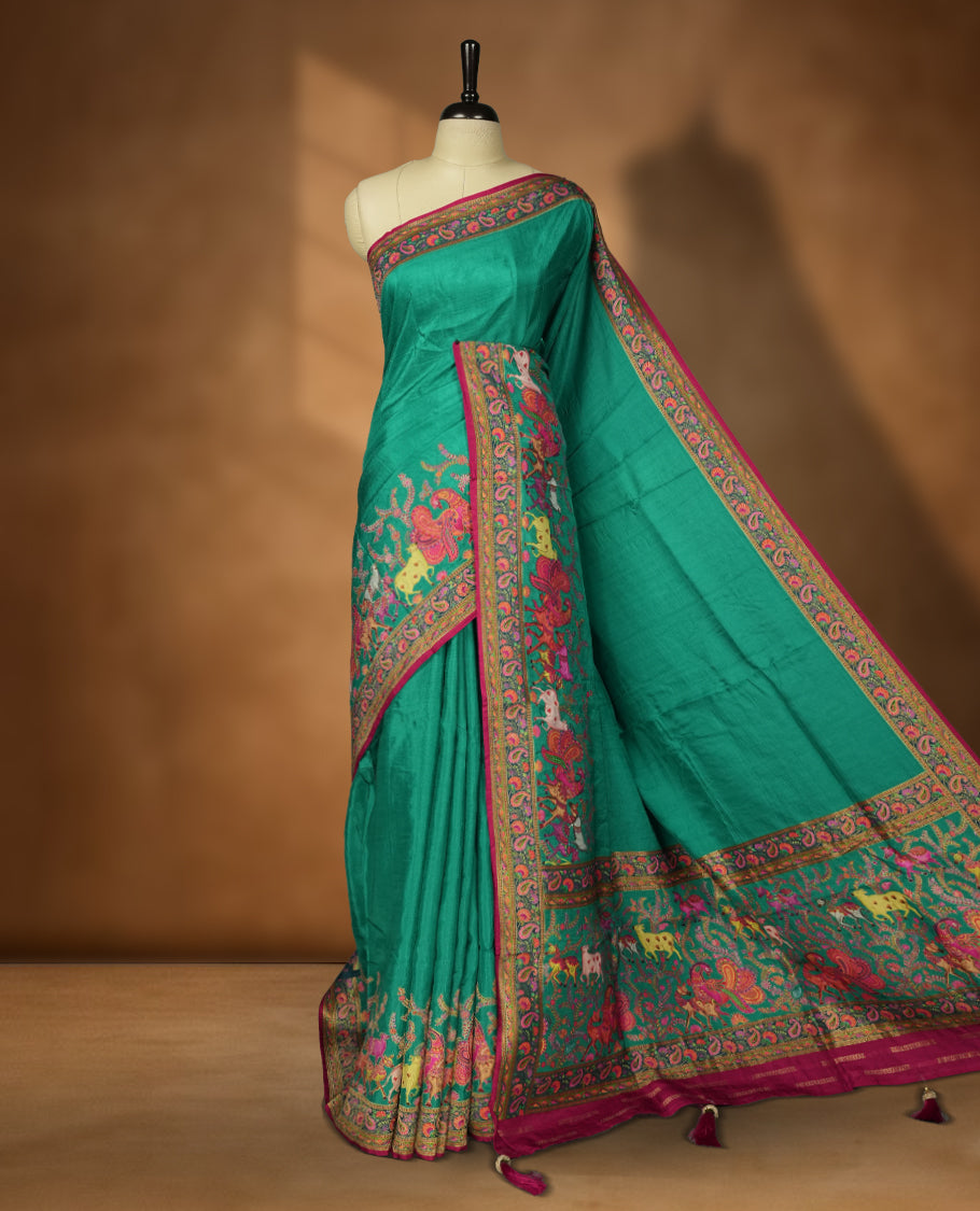 Teal Green Pashmina Silk Saree with Plain Body, Featuring Intricately Embroidered Multicolor Elephant and Peacock Motifs on Vibrant Pink-Gold Zari Border & Grand Pallu, Paired with Matching Blouse Piece