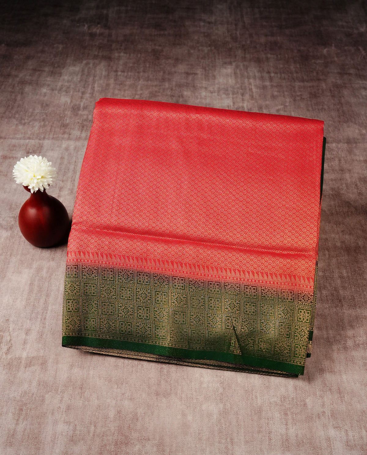 Red colour softie silk saree featuring gold zari, rich pallu floral pattern brocade body, with contrasting green colour patterned border.paired with matching blouse piece.