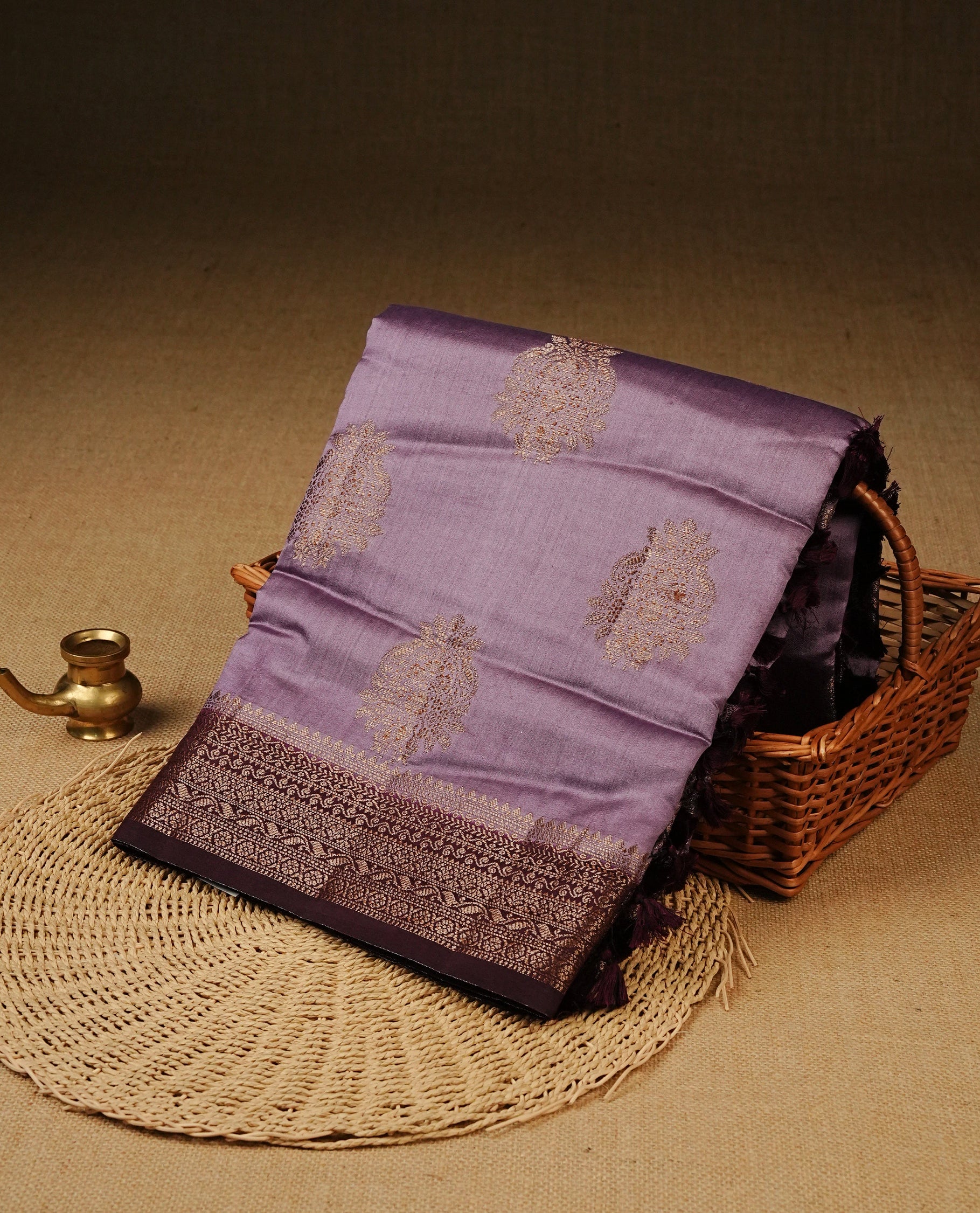 Lavender Colour Tussar Silk saree with elegant antique zari floral motifs On Body, a contrasting Wine zari border, a rich zari pallu, Paired With a matching blouse piece.