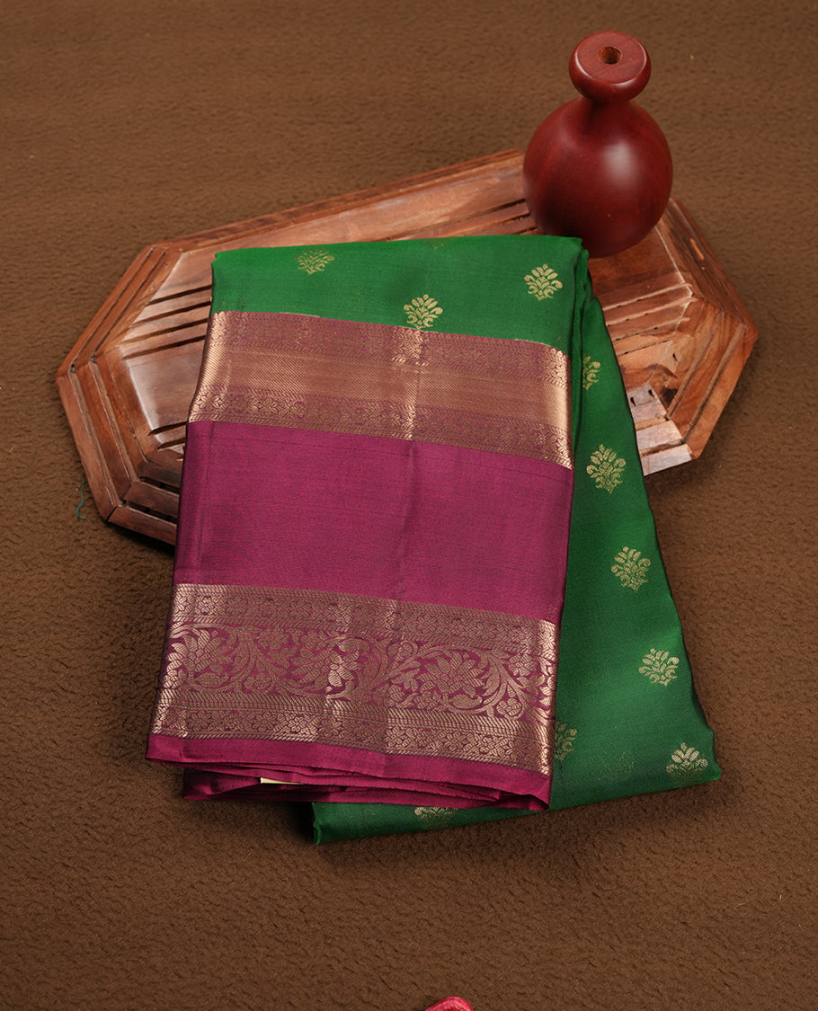 Green colour soft silk saree featuring gold zari motifs on the body, complemented by a contrast Maroon traditional zari border and pallu, paired with a matching blouse piece.