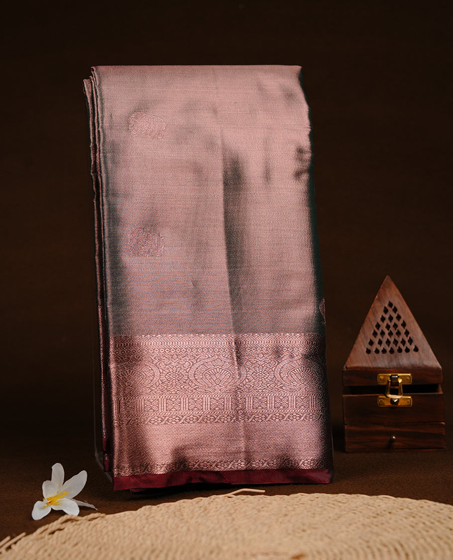Green and copper double shade colour semi tissue silk saree featuring pattern on body, contrast Maroon colour with gold zari traditional border, paired with matching blouse piece.