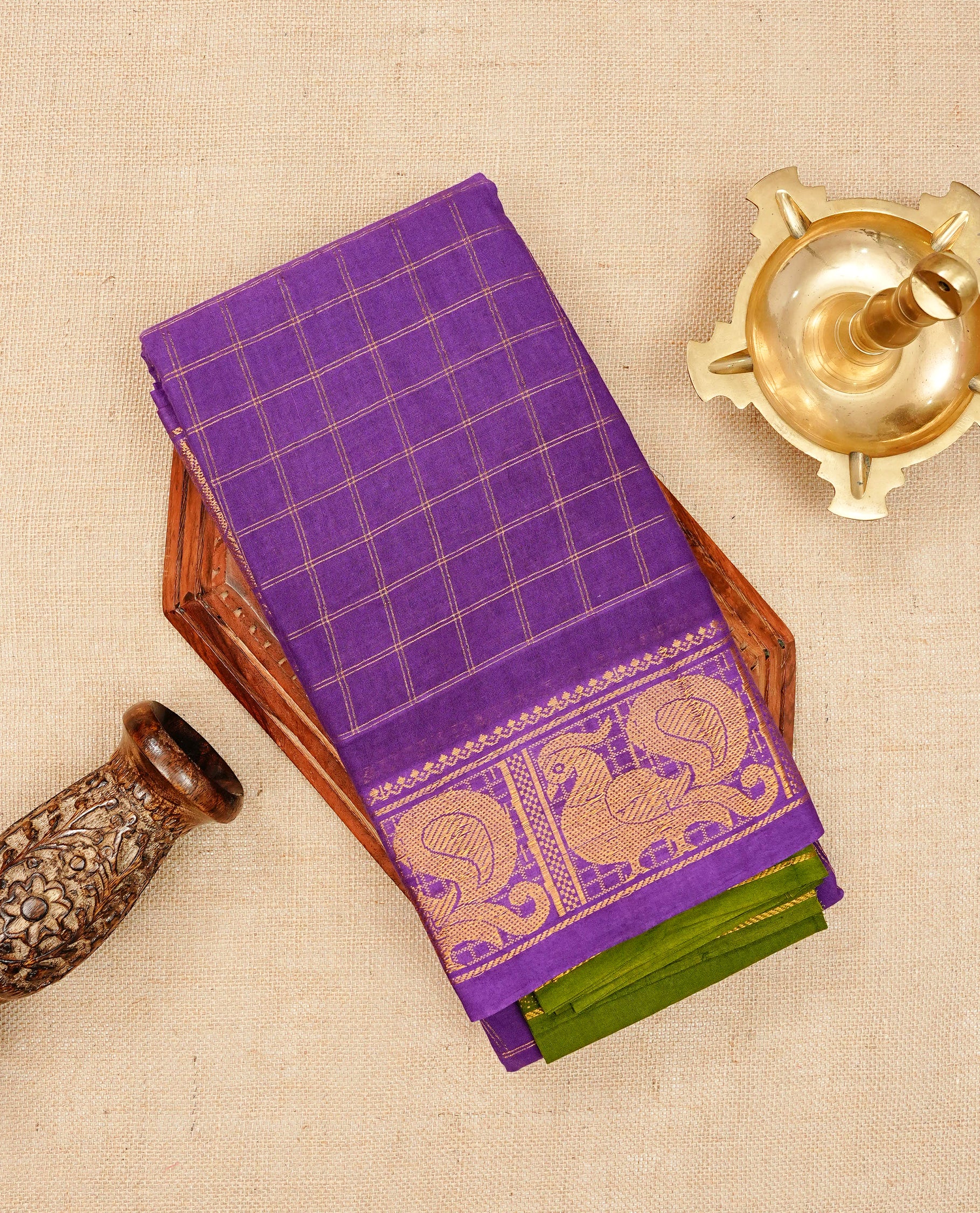 Violet Sungudi cotton saree featuring elegant gold zari checks across the body, complemented by a rich gold zari peacock border. Paired with a matching blouse piece
