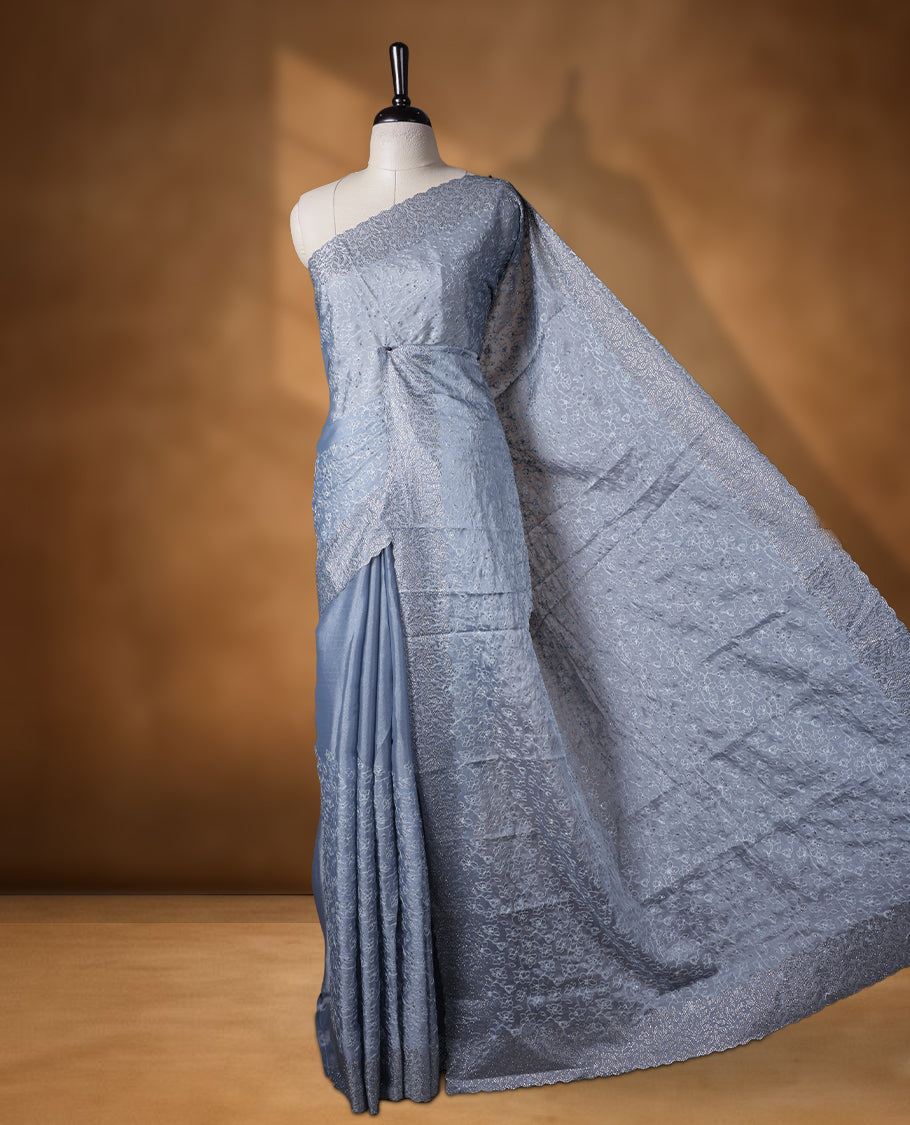 Ash blue colour velvet chiffon designer saree, featuring self colour thread embroidery kodi work on body, stone work and all over motifs on border and pallu, Paired with matching blouse.