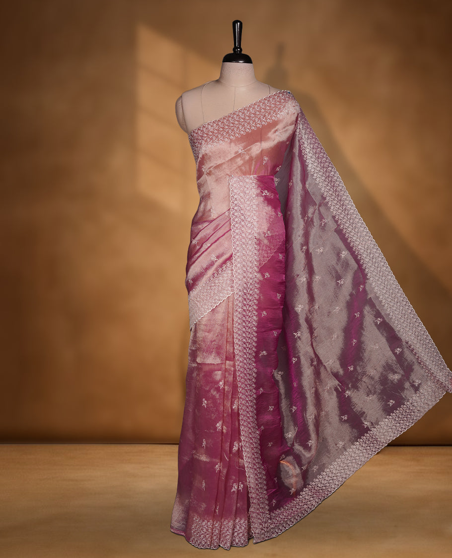 Pastel Mulberry colour net organza saree featuring white thread embroidery motifs on body and thread detailing on the border and paired matching blouse.