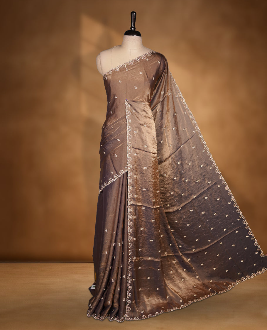 Antique Gold Colour Chiffon Designer Saree featuring Delicate White Stone Work All Over the Body, with Stone Detailing on the Border and Pallu, paired with a Matching Blouse.