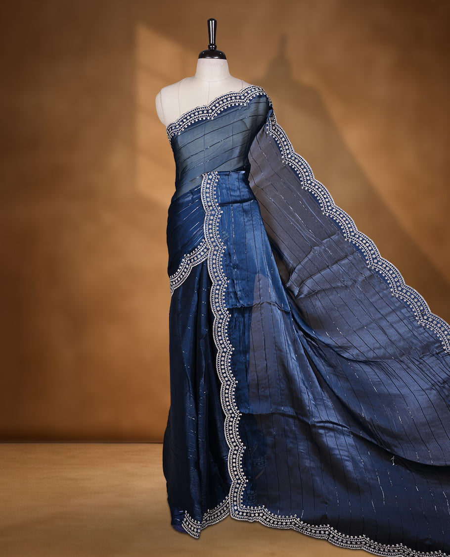 Dark blue colour chiffon designer saree, featuring self colour beats stripes on body, heavy gold stone patttern on border and pallu, Paired with matching blouse.
