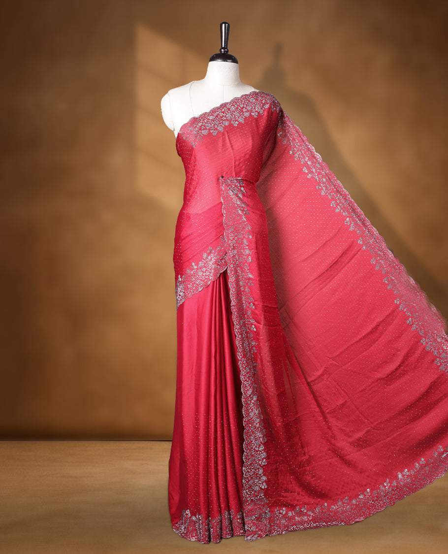 Red colour shimmer designer saree, featuring white scattered stone on body, stone work and heavy stone floral pattern on border and pallu, Paired with matching blouse.