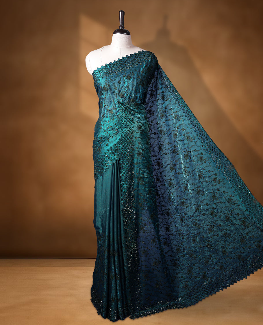 Dark pine green colour velvet chiffon designer saree, featuring black thread embroidery kodi pattern on body, black cut stone work and heavy stone border, pallu and Paired with matching blouse.