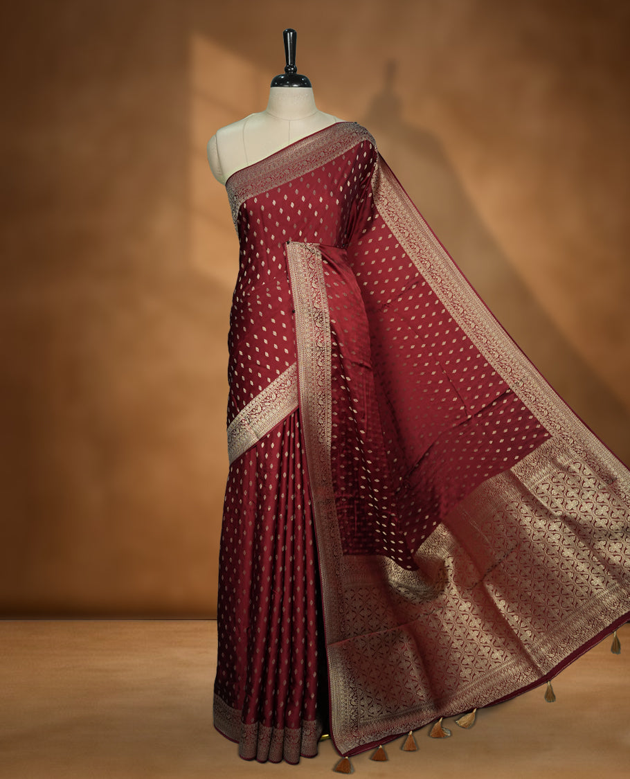 Maroon Colour semi Banaras satin crepe saree with Gold Zari Buti Motifs, Traditional Gold Geometric Pallu, Elaborate Woven Border, Decorative Tassels with Matching Blouse