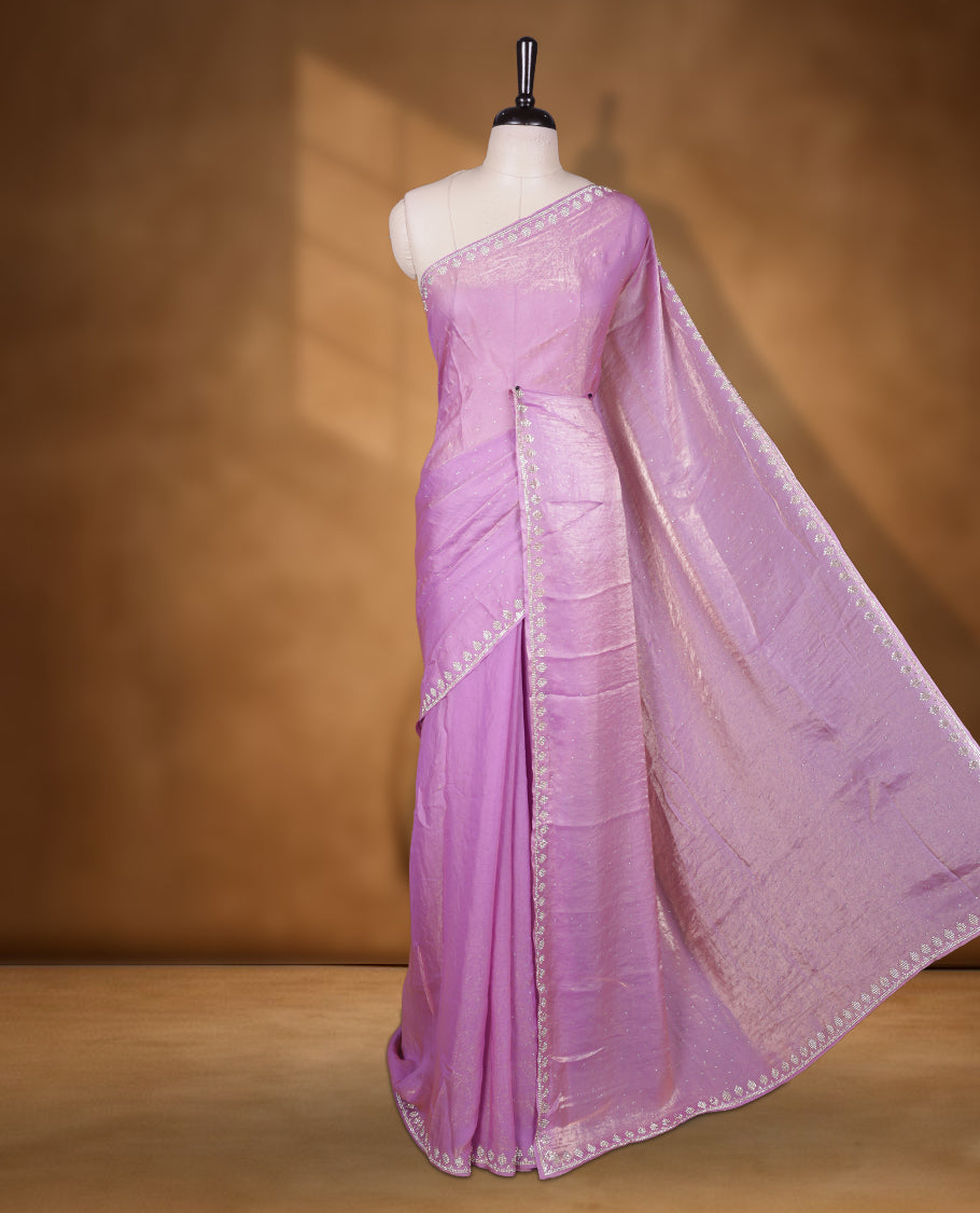 Lavender & pink double shade Colour net shimmer fancy saree adorned with scattered gold stone buttas all over the body, paired with a delicate stone worked border and matching blouse