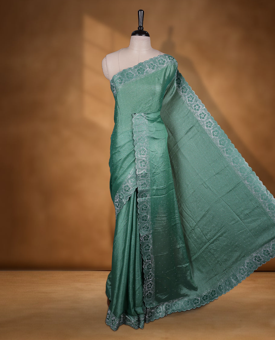 Pastel green colour shimmer designer saree, featuring white scattered stone on body, stone work and heavy stone floral pattern on border and pallu, Paired with matching blouse.