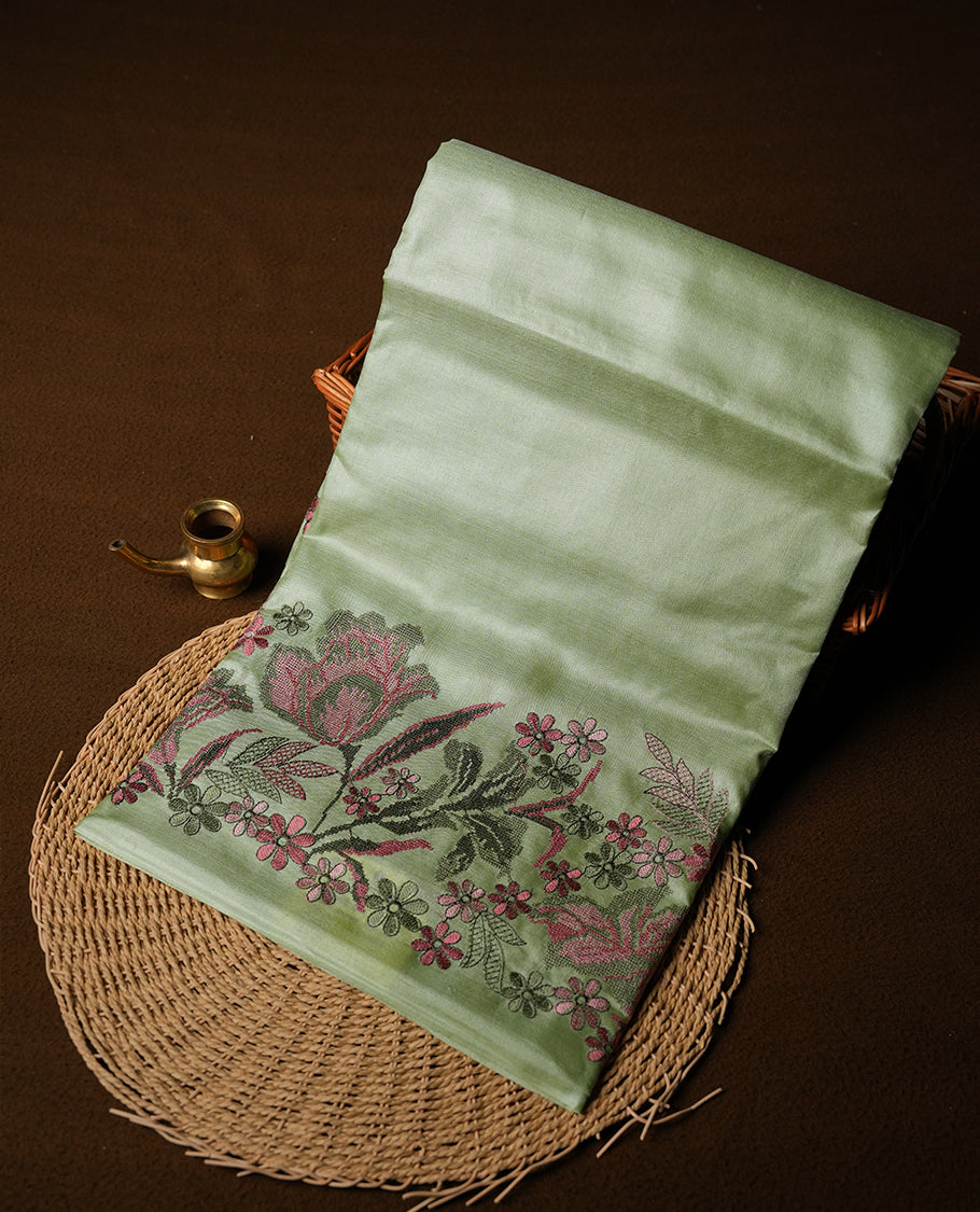 Pastel green colour Pure tusser silk saree featuring finely crafted floral thread embroidery detailing on the border, pallu and with matching blouse piece.