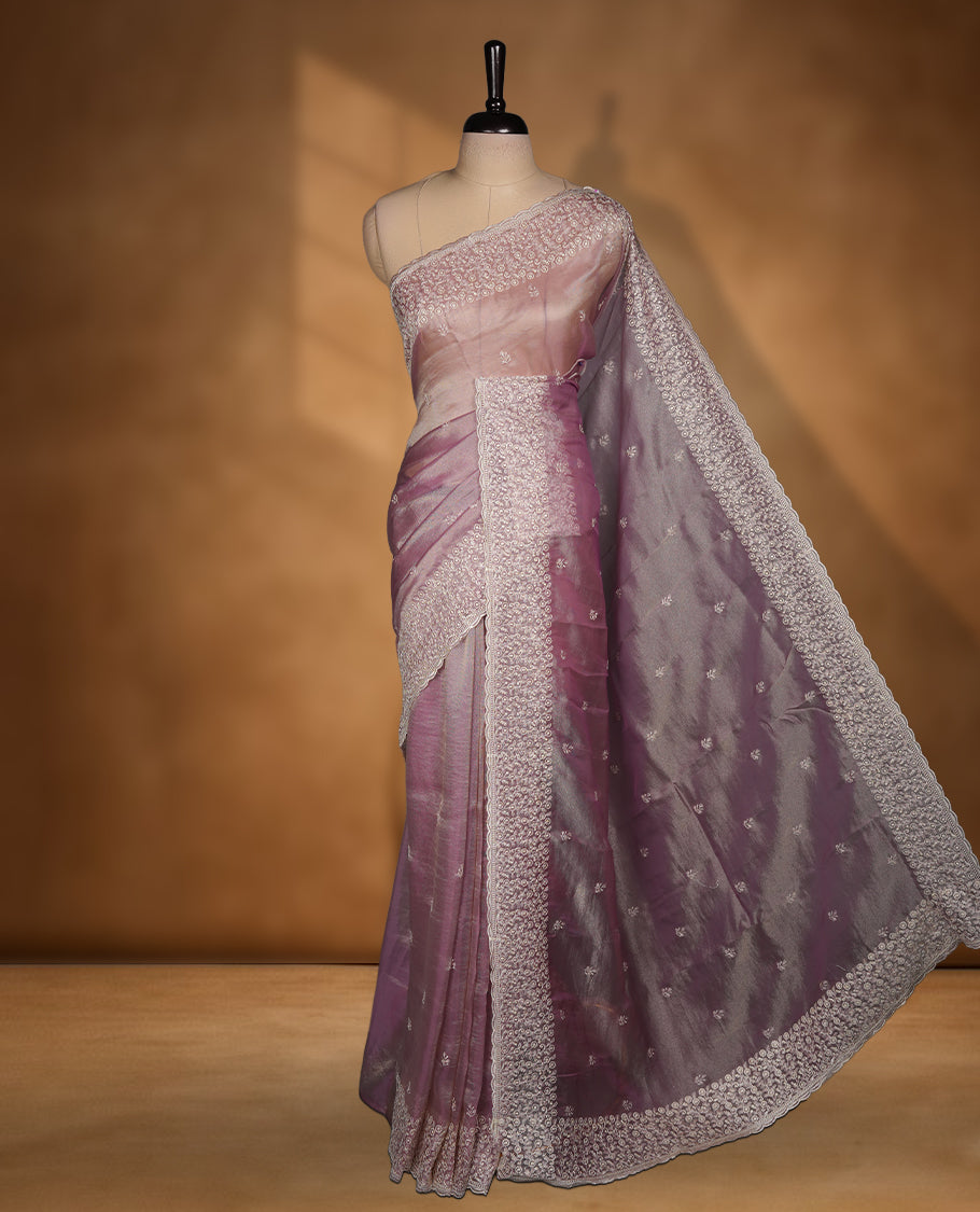 Pastel Lavender colour net organza saree featuring white thread embroidery motifs on body and thread detailing on the border and paired matching blouse.