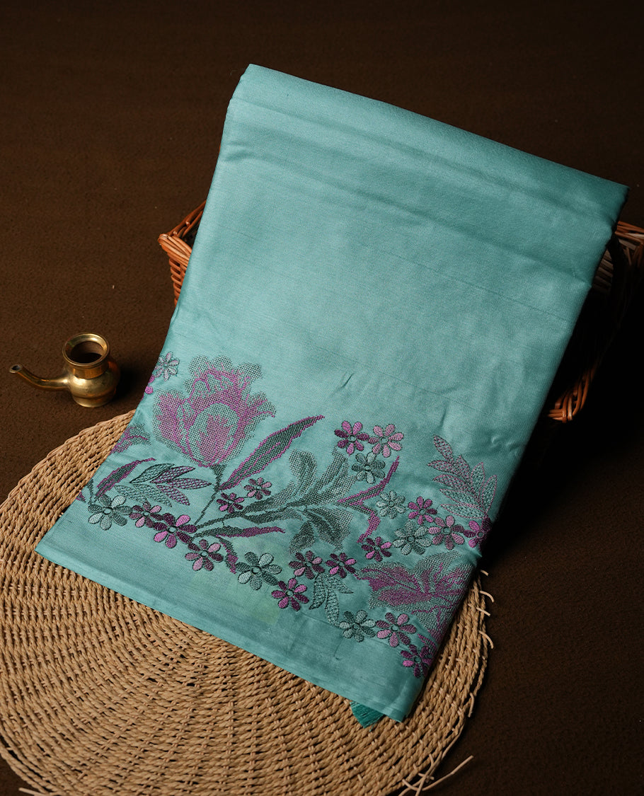 Pastel blue colour Pure tusser silk saree featuring finely crafted floral thread embroidery detailing on the border, pallu and with matching blouse piece.