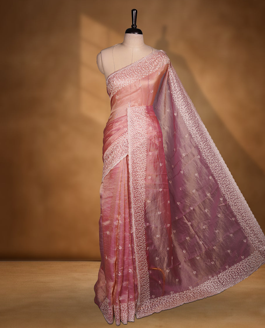 Pastel Pink colour net organza saree featuring white thread embroidery motifs on body and thread detailing on the border and paired matching blouse.