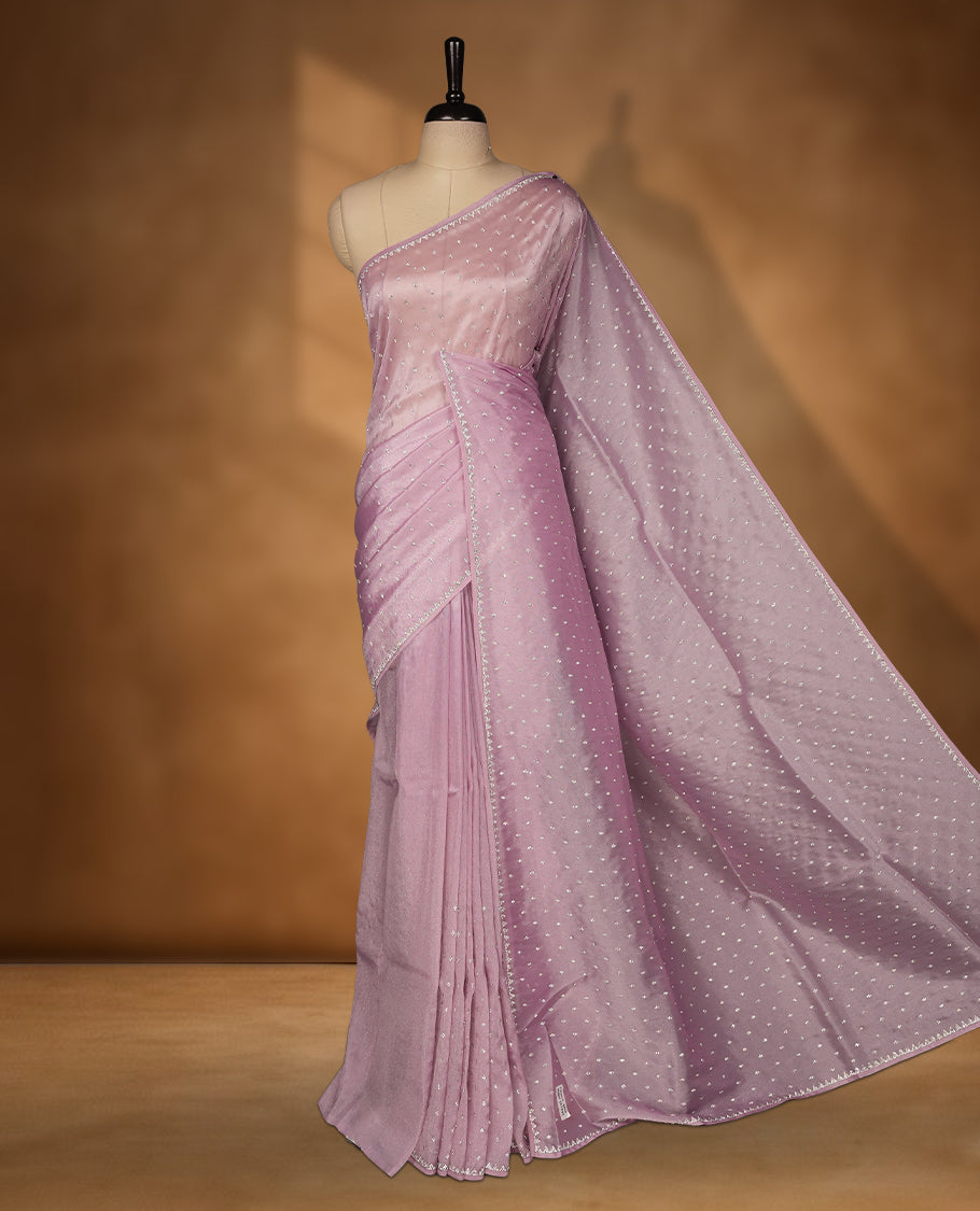 Light Purple Colour net shimmer fancy saree adorned with white stone buttas all over the body, paired with a delicate stone worked border and matching blouse