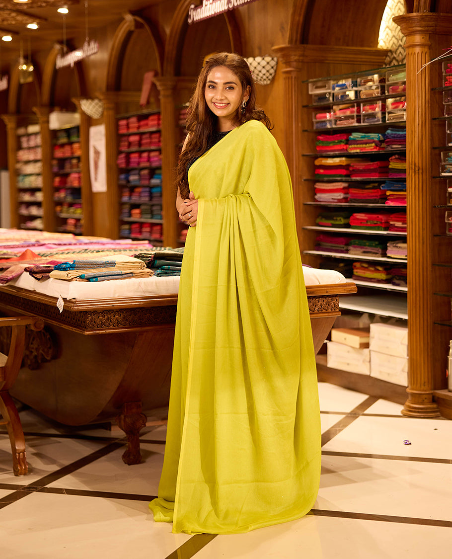 Lemon Yellow colour viscose saree in rich teal shade featuring a subtle sheen and lightweight drape, enhanced with satin piping finished border, paired with a matching blouse piece
