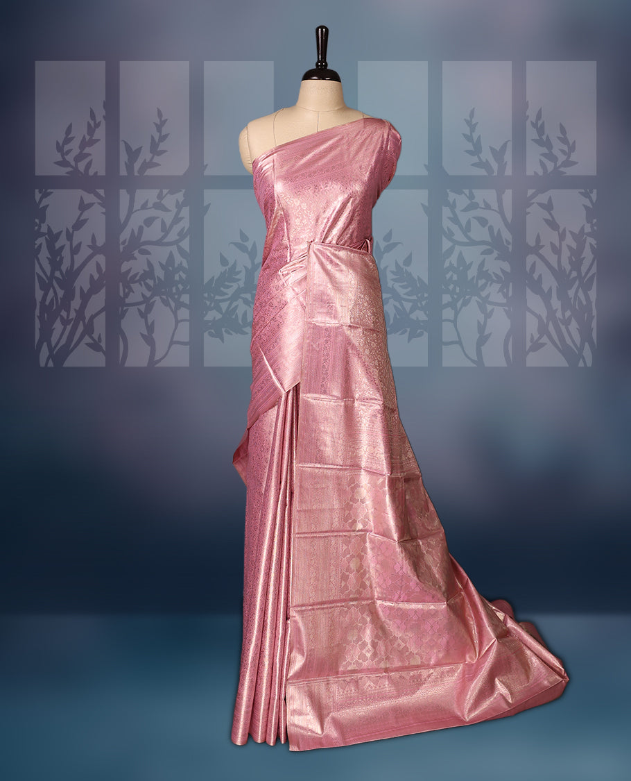 Baby pink colour semi silk brocade saree featuring delicate self design brocade patterns across the body, complemented by a rich self colour woven border and pallu, paired with a matching blouse.