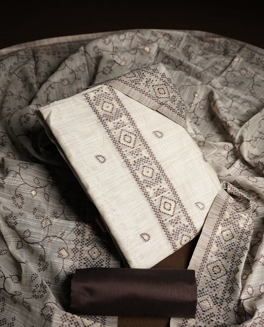 Cream colour churidhar material featuring Brown colour thread embroidery on the front panel, floral thread pattern dupatta with elegant border, and matching plain bottom.