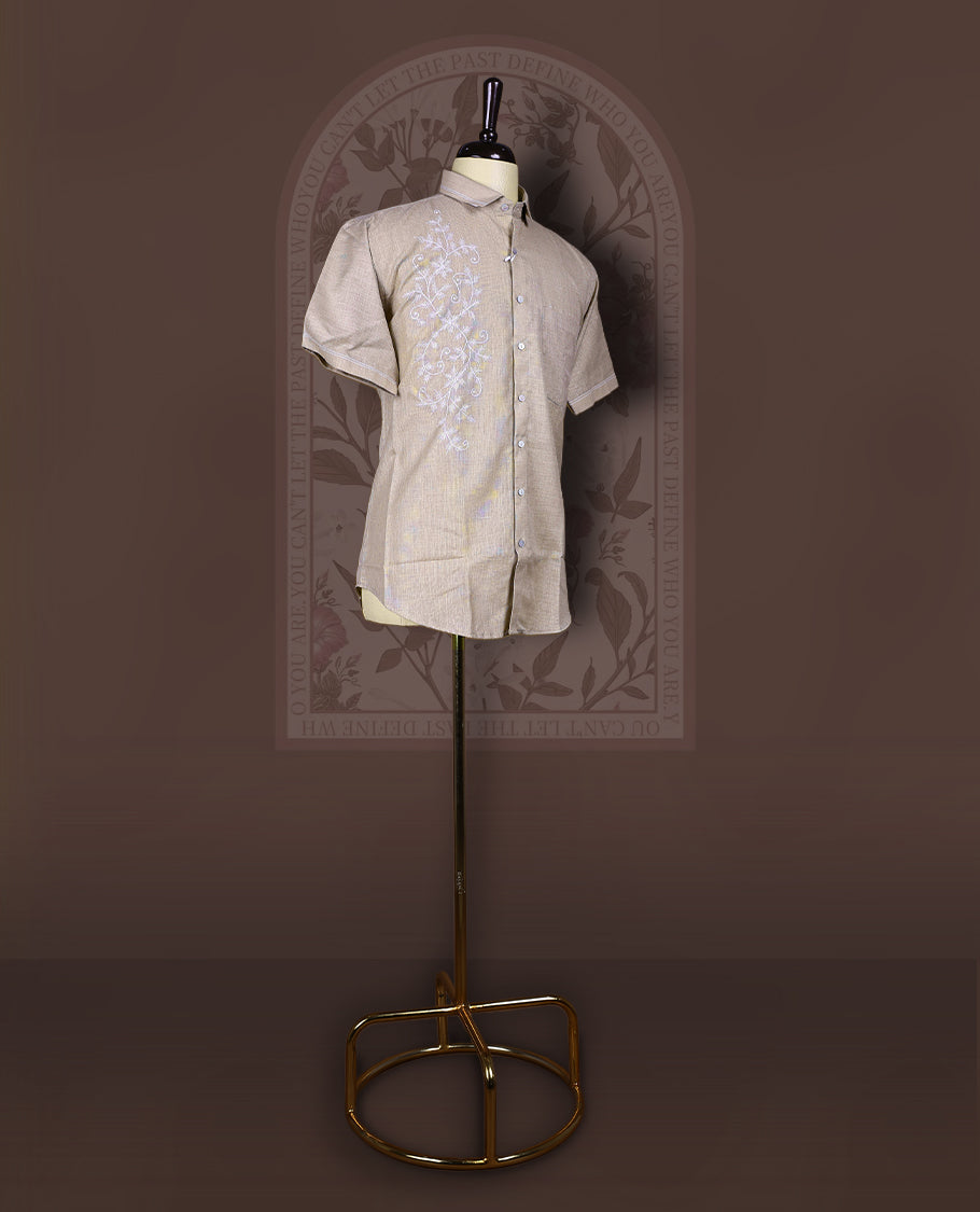 Taupe cotton linen short sleeve shirt featuring intricate white floral vine embroidery on the front, Designed with a mandarin collar and button-down style, blending artisanal detail with modern elegance.