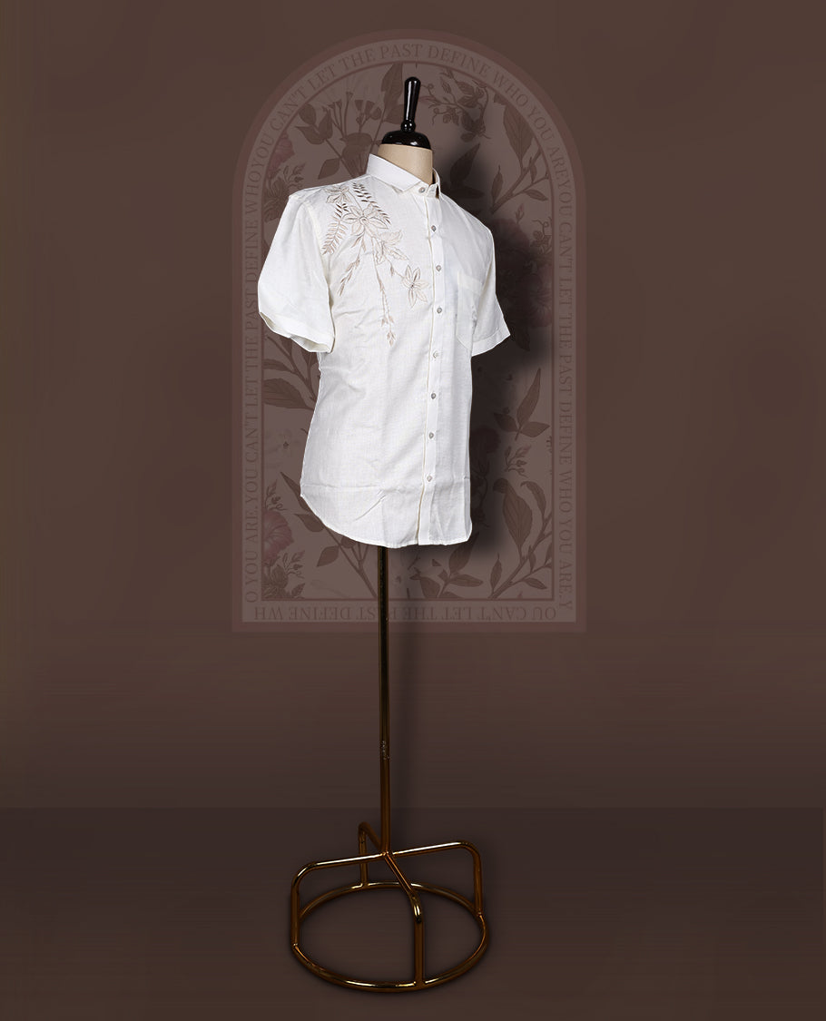 Off White colour cotton linen shirt featuring delicate embroidery work on the shoulder, designed with a mandarin collar and short sleeves for a refined yet comfortable style.