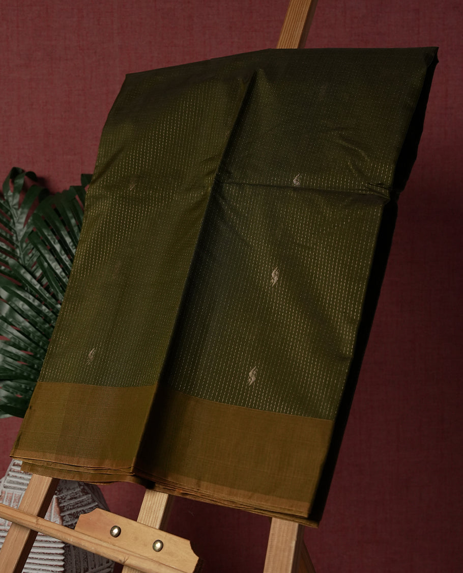 Olive green colour pure handloom cotton saree featuring fine golden stripes with delicate motifs, paired with a rich zari border for a traditional yet elegant look, perfect for graceful occasions & Comes with matching blouse.