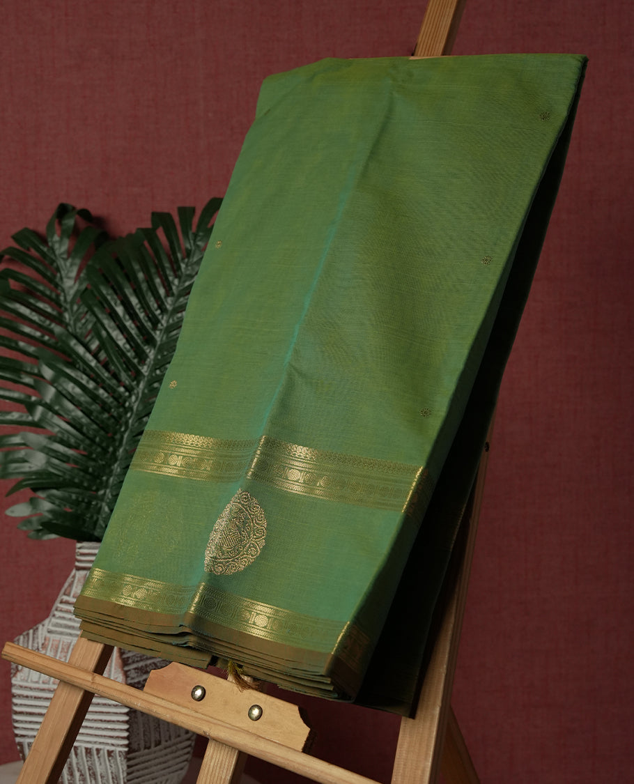 Fern Green colour Pure Kanchi cotton saree featuring delicate golden buttas and a rich zari border with intricate motifs & Paired with a matching blouse, it exudes timeless elegance, perfect for festive and traditional occasions.