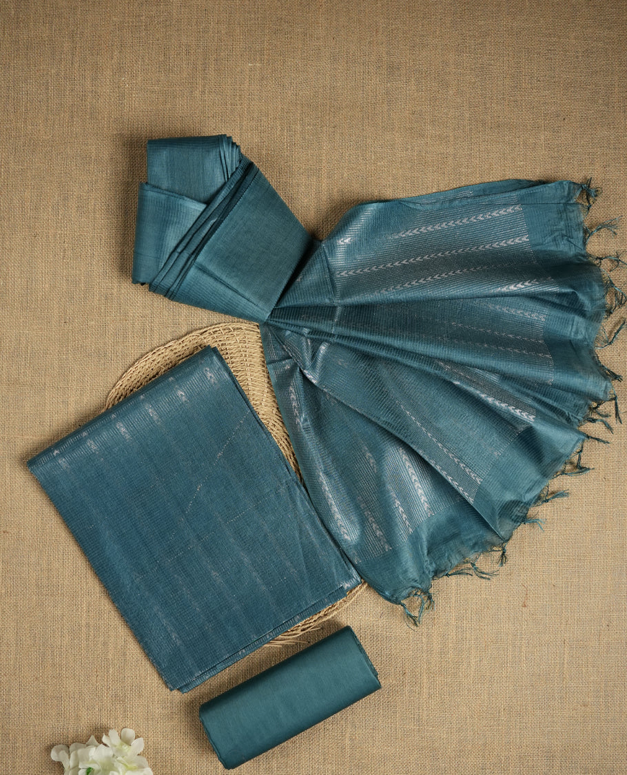 Steel blue colour Tussar suit material adorned with intricate woven patterns and subtle motifs, exuding ethnic elegance & Paired with a beautifully bordered dupatta and a matching plain bottom.