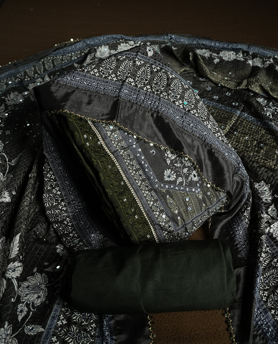 Dark Green colour churidhar material featuring Mirror and thread embroidery, foral print pattern on the self colour front panel, floral digital printed dupatta with elegant border, and matching plain bottom
