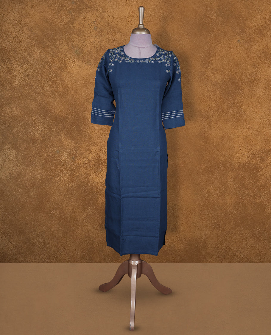 Deep blue colour kurti by Talisha with round neckline, delicate white floral embroidery on the neck and sleeves, straight calf‑length silhouette, and three‑quarter sleeves with contrast stripe cuffs.