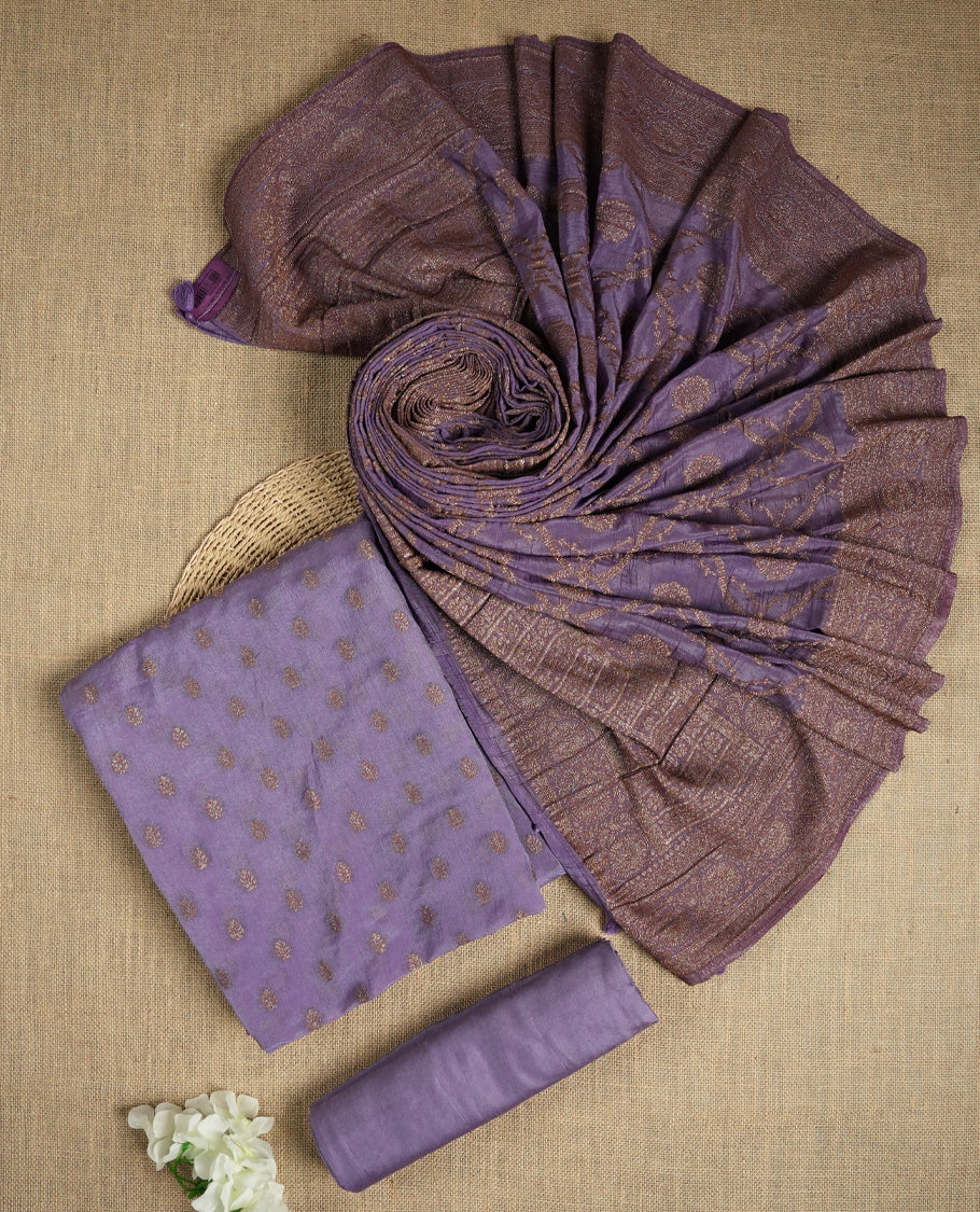 Lavender colour suit material adorned with delicate light copper toned zari work & Comes with a beautifully woven dupatta and matching plain bottom fabric.