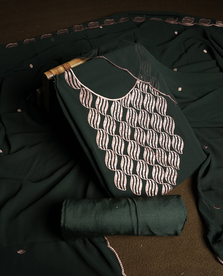 Deep green colour churidar material adorned with intricate sequin embroidery on the neckline and body & dupatta comes with embroidered motifs and matching scalloped embroidered border & and plain bottom.
