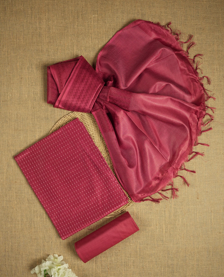 Light Maroon colour tussar suit material adorned with intricate woven patterns and subtle motifs, exuding ethnic elegance & Paired with a beautifully bordered dupatta and a matching plain bottom.