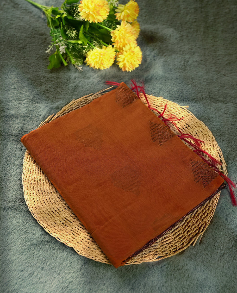 Mustard colour soft silk cotton saree adorned with copper zari motifs and a shimmering copper zari border, Enhanced by a beautifully rich brown colour woven pallu & Comes with a matching blouse piece for a complete look.