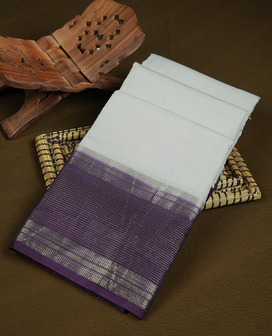 white colour mixed chanderi cotton saree with plain body, pallu featuring rose gold zari border, and matching deep purple blouse.