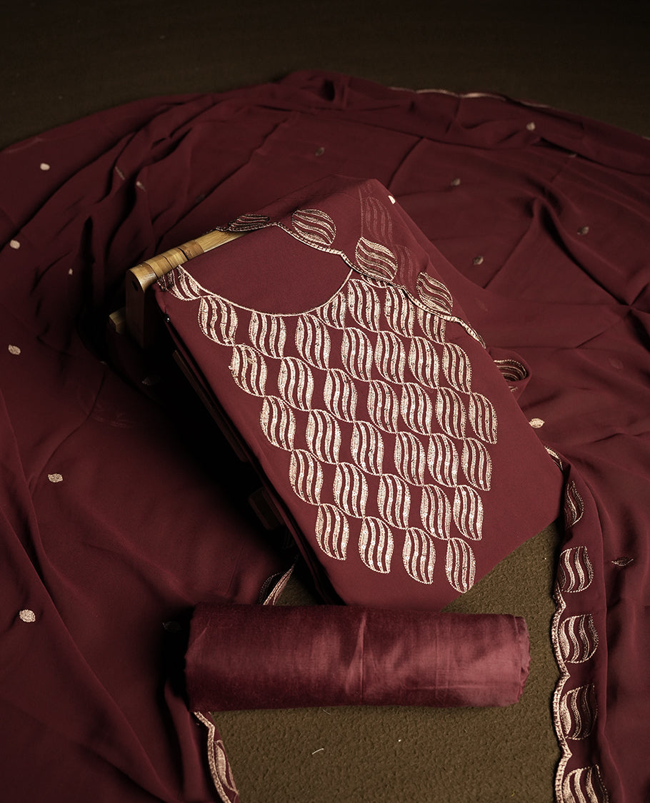 Dark Maroon colour churidar material adorned with intricate sequin embroidery on the neckline and body & dupatta comes with embroidered motifs and matching scalloped embroidered border & and plain bottom.