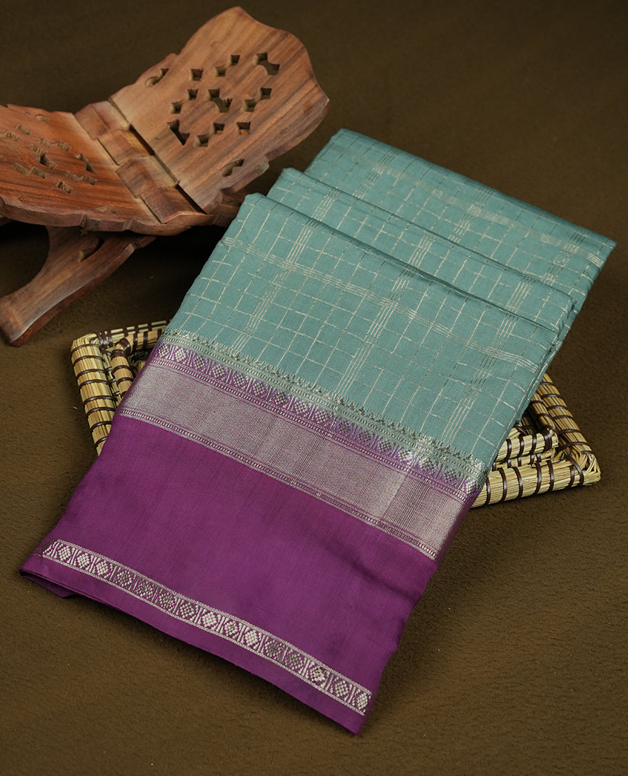Teal green colour mixed chanderi cotton saree featuring gold checkered body, purple pallu with rose gold zari border, and matching blouse.